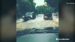 Cars battle flooded roads after heavy rain