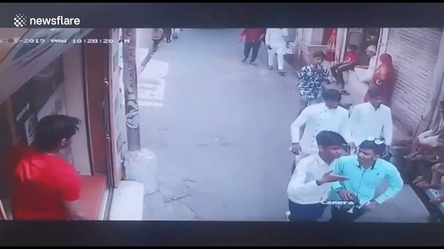 Terrifying moment raging bull rams into shoppers in northern India