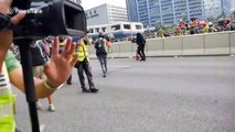 Police rush Hong Kong protesters after being pelted with rocks