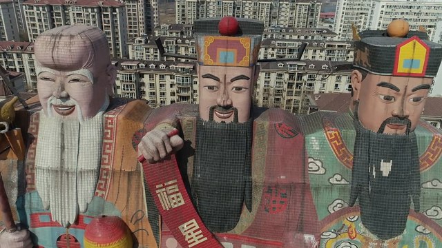 Giant gods stand guard over Chinese building in Beijing suburb
