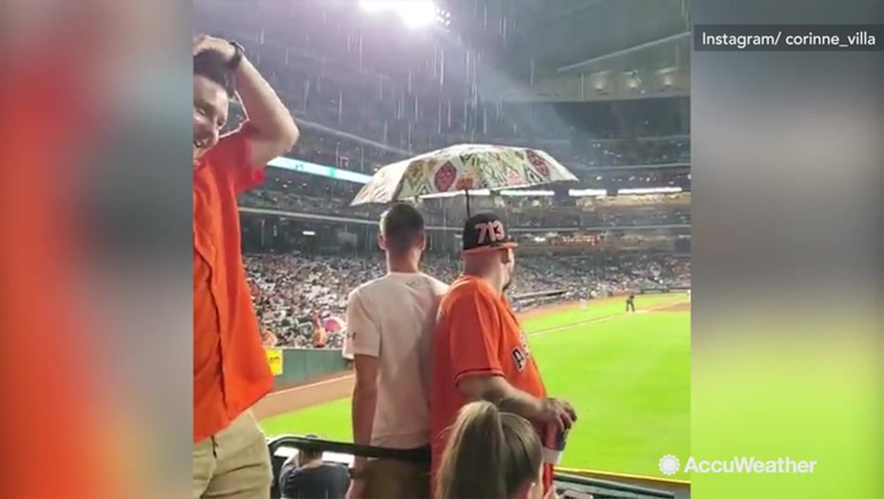 Rain pours down onto fans at Minute Maid Park during Houston Astros game