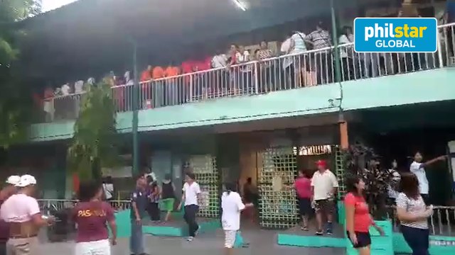 Early voters fall in line to cast their votes at the Manuel L. Quezon Elementary School in Tondo, Manila