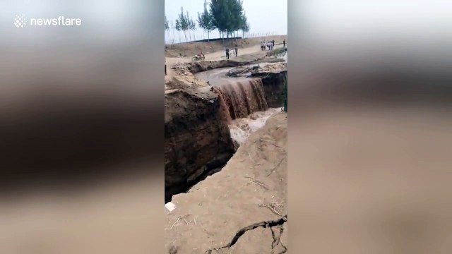 Chinese man luckily survives fall into river after bank collapses under him