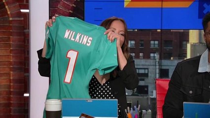 Kay Adams receives the first Christian Wilkins jersey