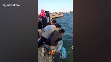 Motorcyclist rescued after skidding into sea in Indonesia