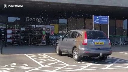 Parked car swarmed by bees outside UK supermarket