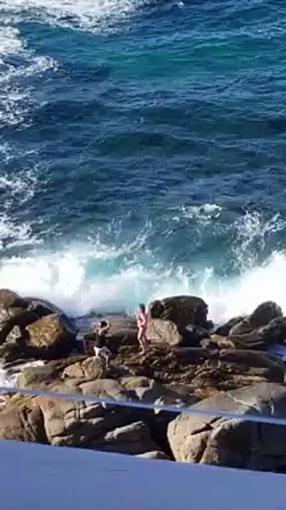 Wave Washes Away Posing People