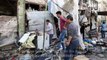 Syrians salvage items following air strikes on jihadist-held town