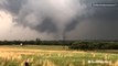 Onlookers film tornado in field