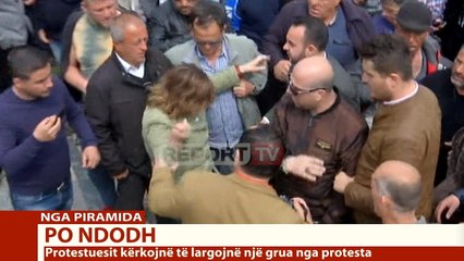 Download Video: Report TV - Protesta e opozitës/ Përplasen fizikisht një burrë dhe një grua