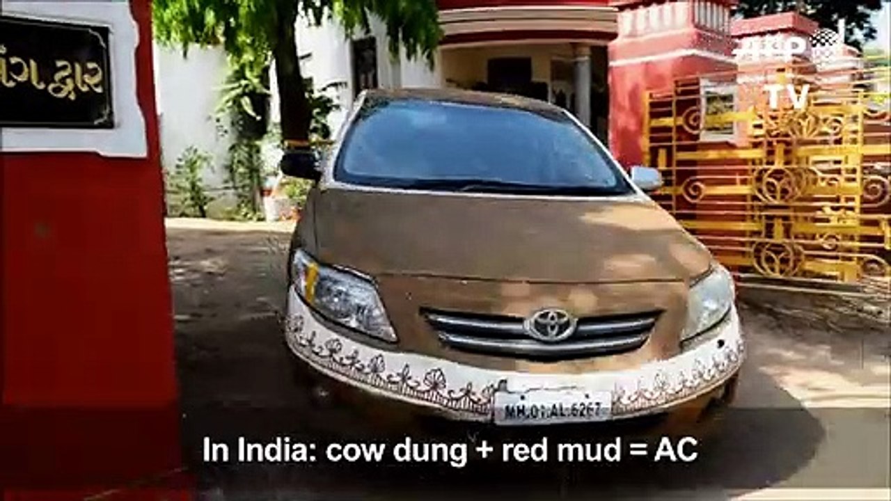 Indian woman covers car in cow dung to avoid heat