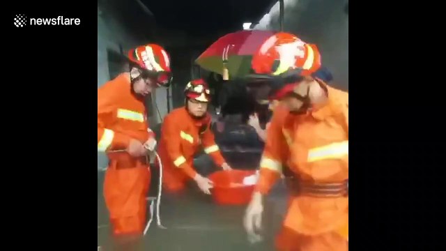 Firefighters rescue residents trapped by floods in China's Guangdong
