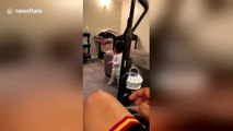 Dad startles adorable baby into walking with vacuum cleaner