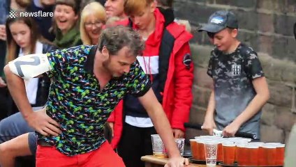 Boozy competitors race around UK town in wheelbarrows drinking beer along the way