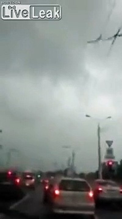 Building rooftop blows into the road