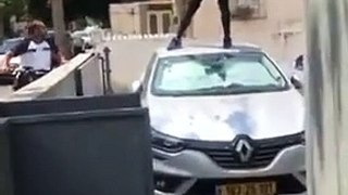 Man jumping on the car roof goes through the windshield