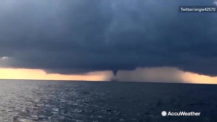 Waterspout glides over ocean