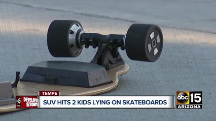 SUV hits two kids on skateboards