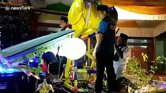 Parade of cars decorated with giant ornaments drive through Indonesian city for Eid al-Fitr