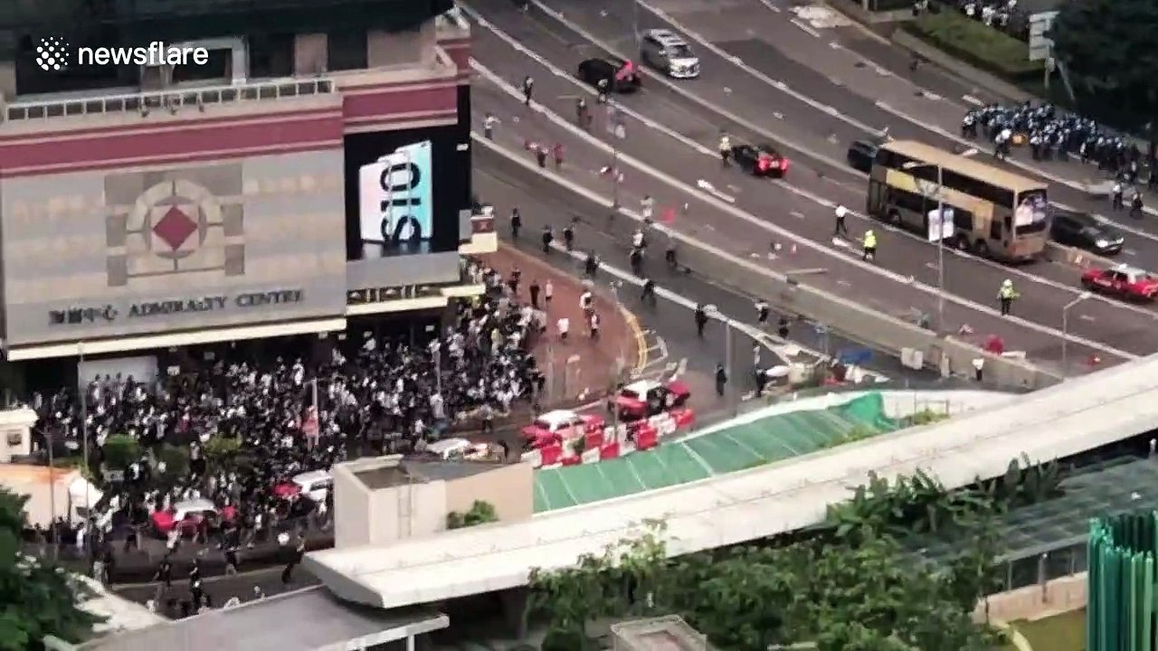 Crowds run away as Hong Kong police clash with protesters