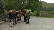 The Duchess of Cambridge admires a girl's plaits