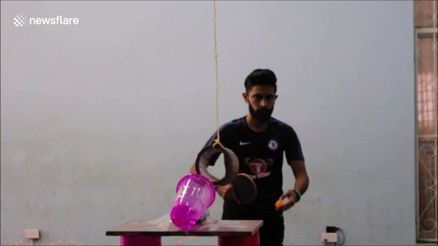 Insane ping pong shot goes clean through spinning tape roll