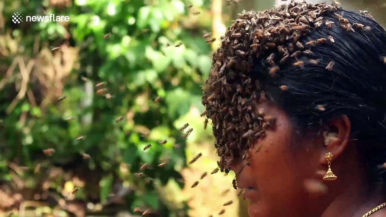 Indian woman covers face with hundreds of bees to create buzz for conservation