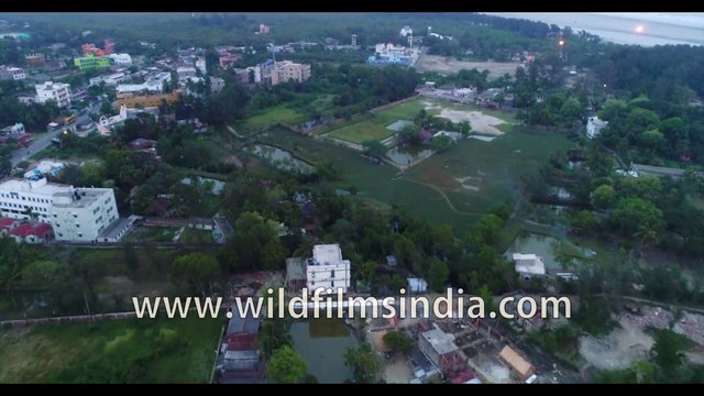 Homes, coastline and farmlands on Bakkhali Beach , West Bengal, India | 4k Aerial stock footage , evening shot