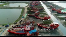 Aerial view of stunning water ways and fishing boats parked during low tide under Dashmile Bridge-4K stock footage