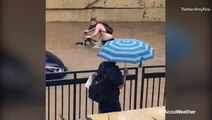 Unlucky man forced to push his bike through floodwaters