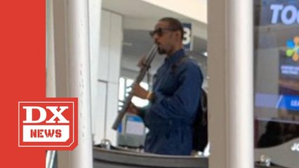 André 3000 Captured Wandering Around Airport Playing A Flute