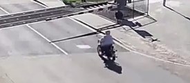 Un motard se prend la barrière d'un passage à niveau et tombe K.O quand le train passe