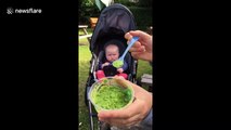This six-month-old girl simply does not want to eat any mushy peas