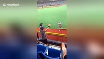 Heartwarming moment baseball player Mike Trout throws a ball to an excited little boy