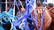 Performers wielding giant paper tissue guns completely cover London bar