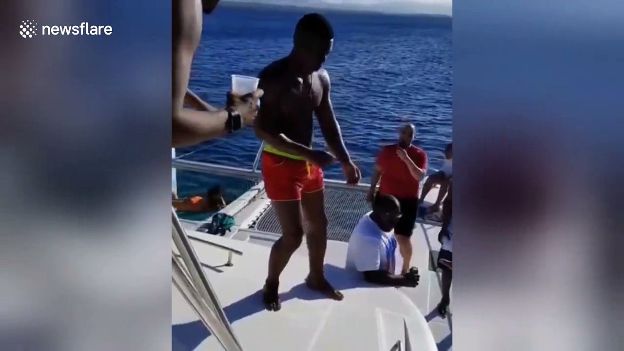 A man fails miserably attempting to jump off a yacht