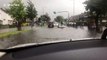 Man sits on roof of stranded car in flooded road in Edinburgh