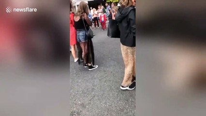 Glasgow locals form pathway for a family of ducks to cross busy road