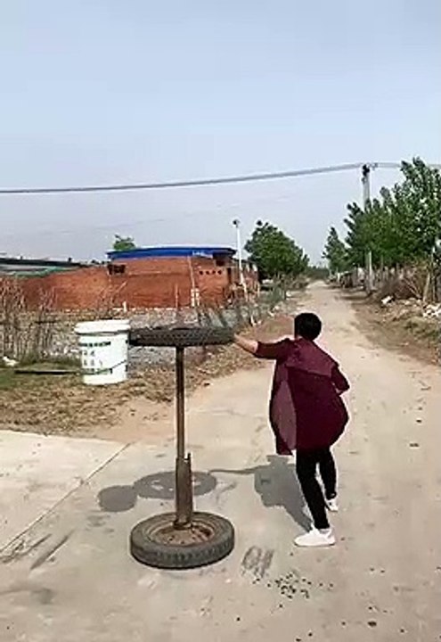 the old basketball in a bucket spinning on a rusty axle and wheel trick