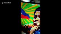 Artist creates recycled straw mural of Philippines president