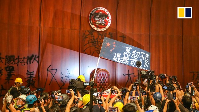 Hundreds of anti-government protesters storm Hong Kong legislature on anniversary of handover to China