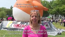 People queue outside the National Mall ahead of July 4 festivities as protesters rally against Trump