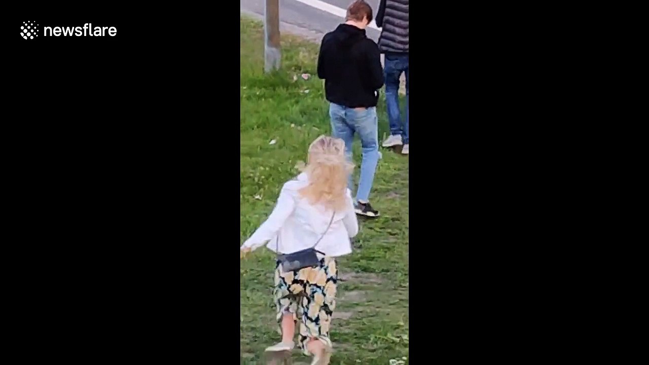 A Woman attempts a cartwheel gone wrong