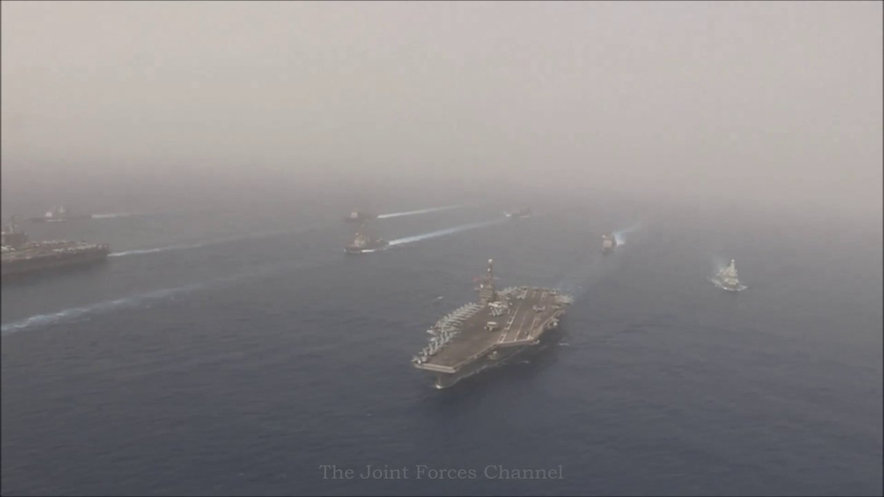 Two Aircraft Carriers in formation Emerging From Dense Fog in the Mediterranean Sea