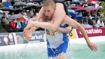 Couples from over a dozen countries compete in wife-carrying championships