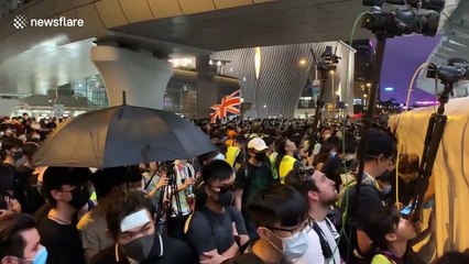 Hong Kong protestors shine flashlights and hurl abuse at police