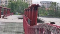 Wooden footbridge collapses during flash flooding in China's Shangrao