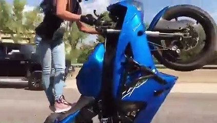 Girl is doing wheelie - wow this girl is incredible as well as crazy!!