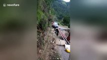 Terrifying moment car crosses damaged mountain road on makeshift track