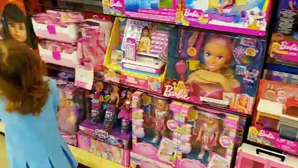 Little Mia is shopping in toy store in Dubai Mall and buying Barbie Doll. Playing with soap baubles